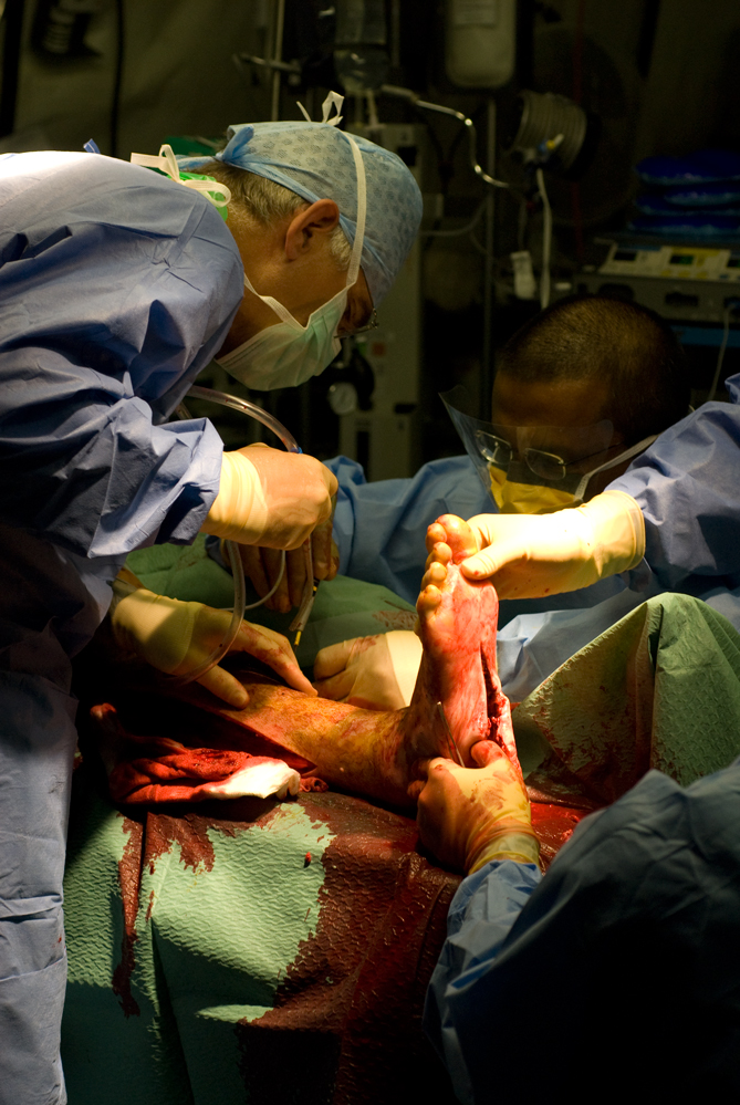 Doctor operating on leg